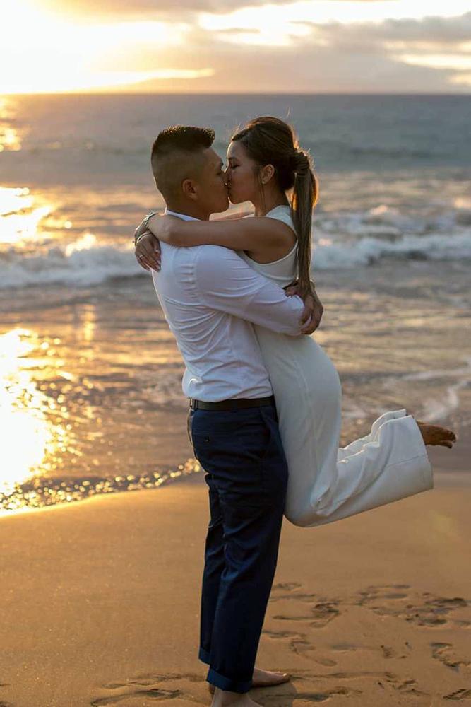 summer proposal ideas couple is kissing on afterglow near the ocean