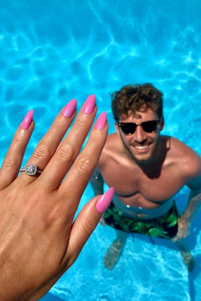 summer proposal ideas man in water and her hand with engagement ring