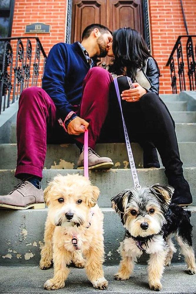 engagement photo ideas couple kiss dogs sit