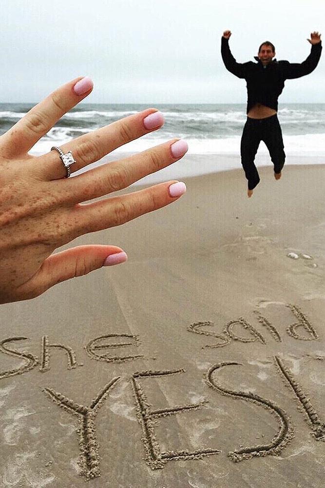 engagement photo ideas very happy man she said yes on a beach