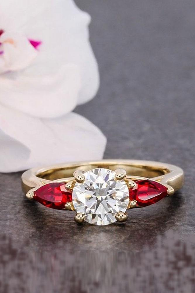 three stones engagement pear ruby center round cut diamonds rose gold
