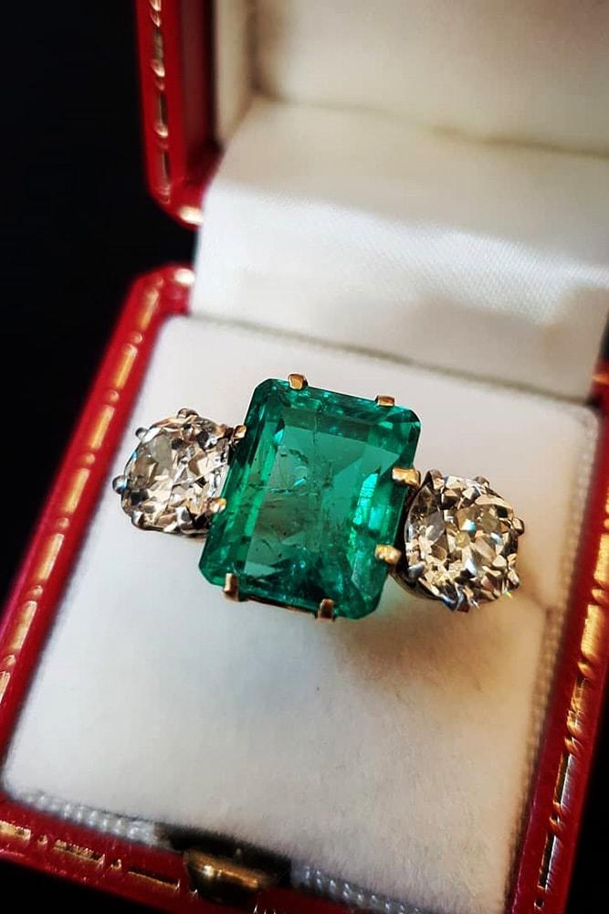 three stones engagement rings yellow gold emerald cut gemstone and round cut diamonds threestone ring