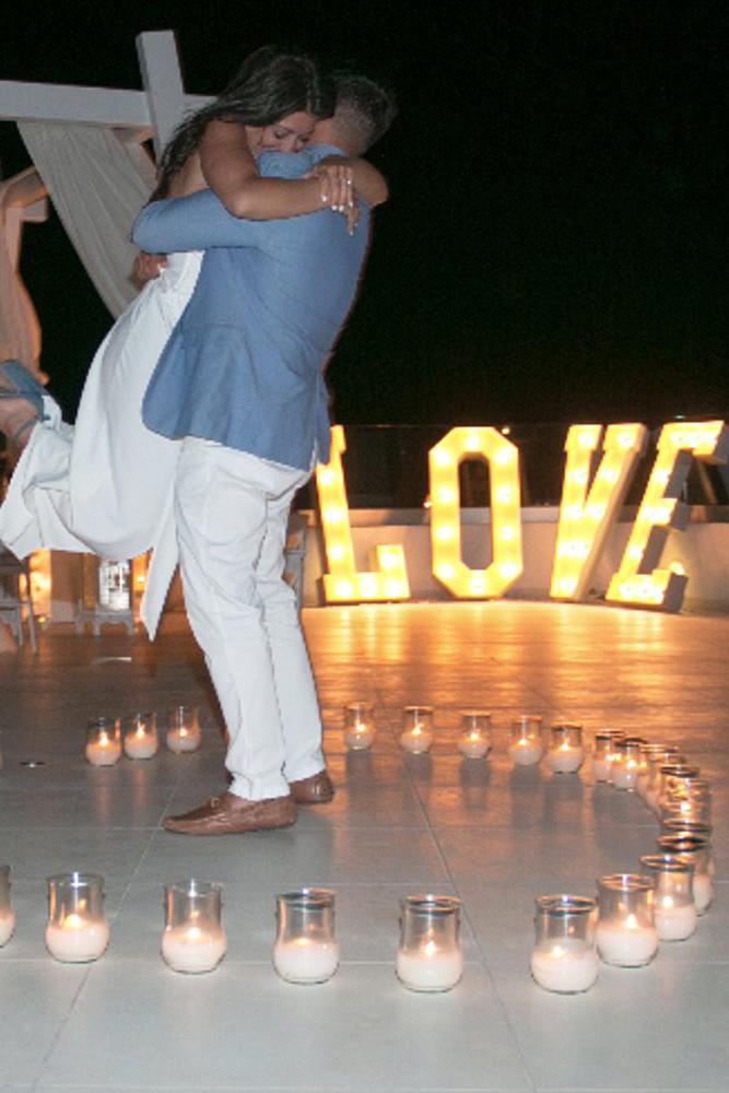 engagement photos man and woman letters hug engaged couple