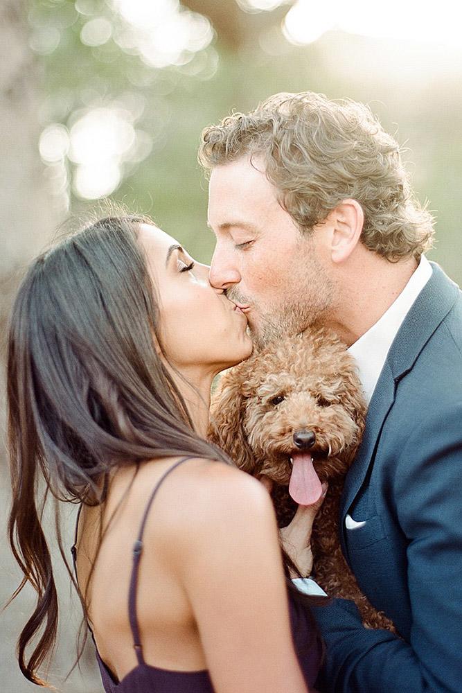 engagement pictures with pets dog and kissing couple