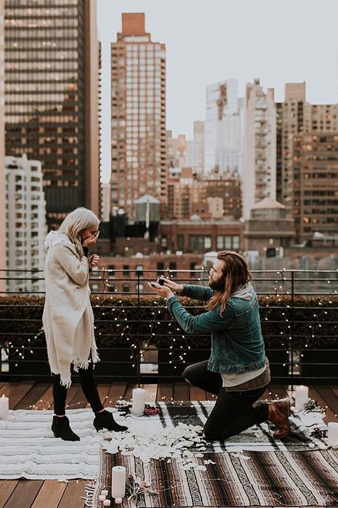 wedding proposal on the roof with candles she surprised