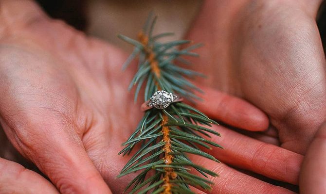 new year engagement photos ring at christmas tree hands antlersandarrowsphoto featured