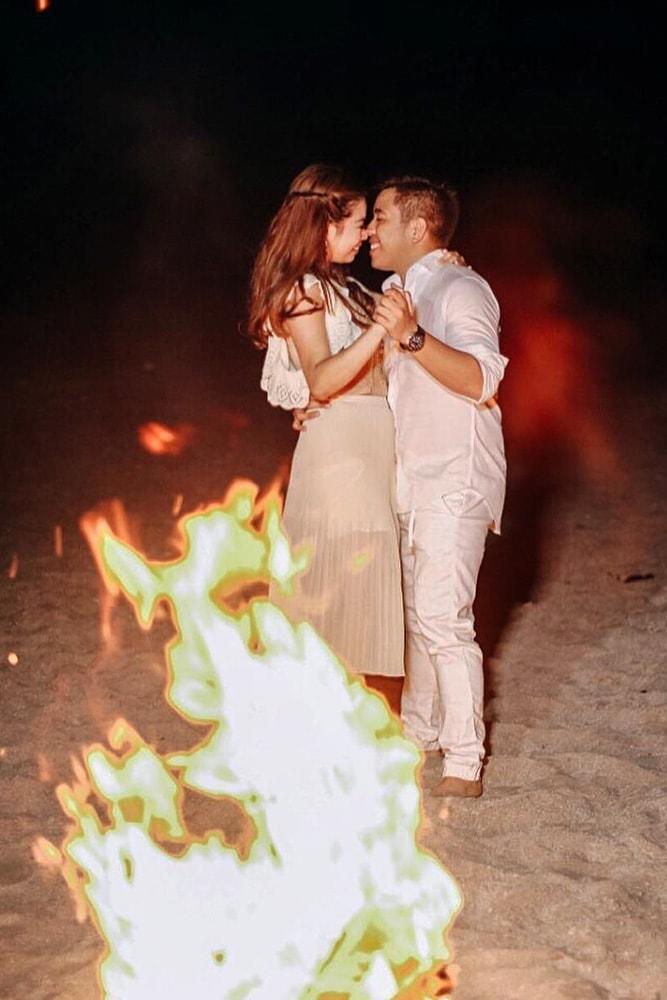 engagement pictures romantic photo ideas dance on the beach at night with bonfire