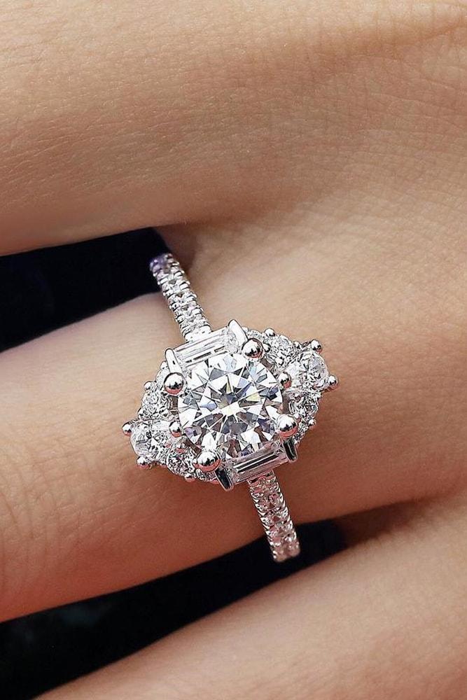 white gold engagement rings modern ring round cut diamond in centre halo with emerald cut and round cut diamonds pave band
