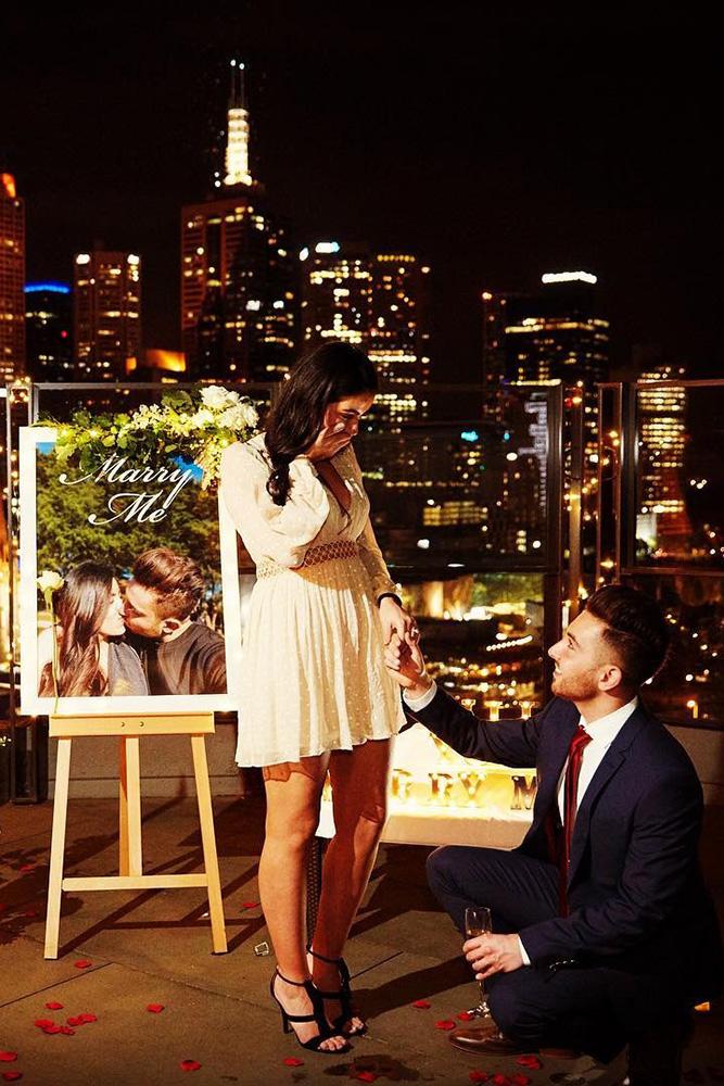 perfect proposals inspired night time roof proposals with candles and flowers