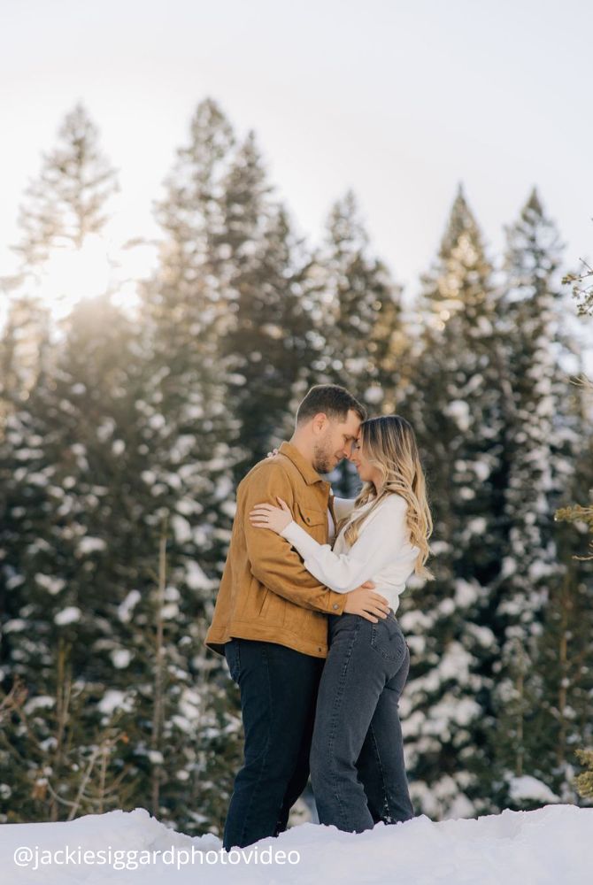 christmas proposal lovers romantically hugging outside snow in winter jackiesiggardphotovideo