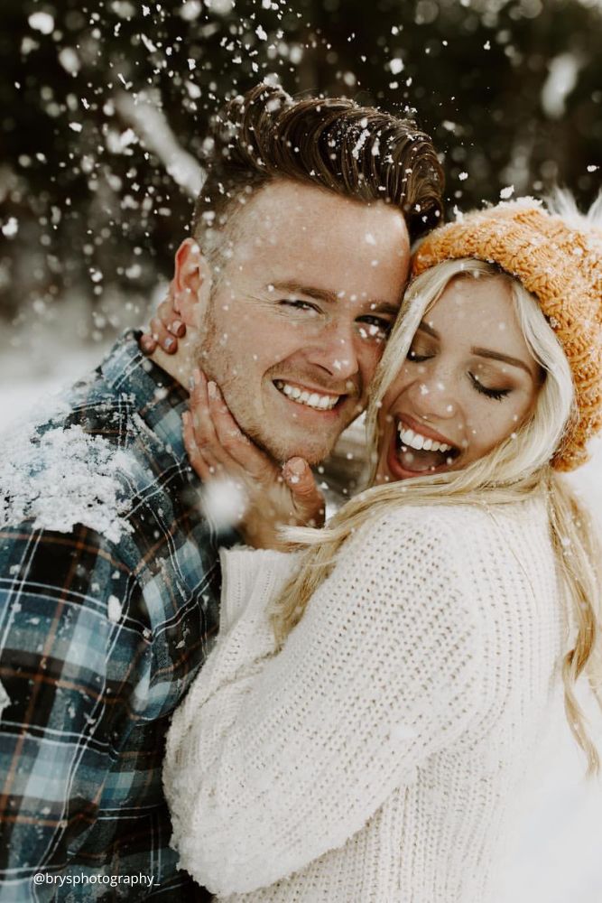 new year engagement photos a man and woman are smiling in the snow brysphotography