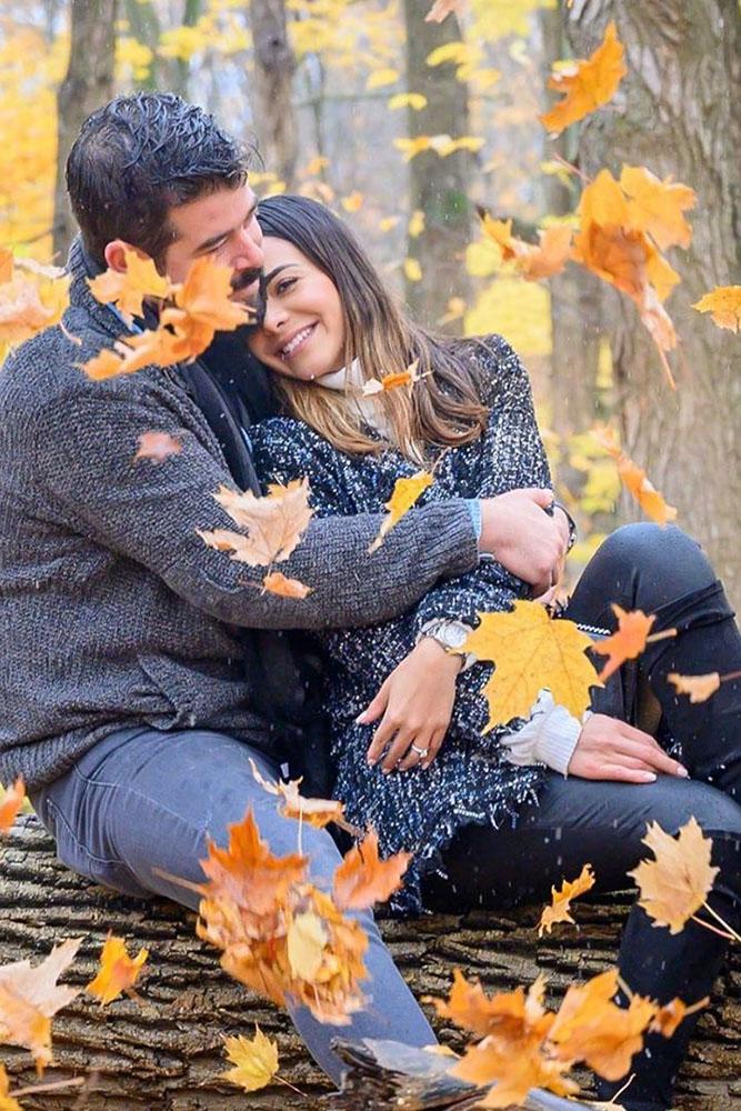 fall proposal ideas hand with engagement rings and yellow leaves