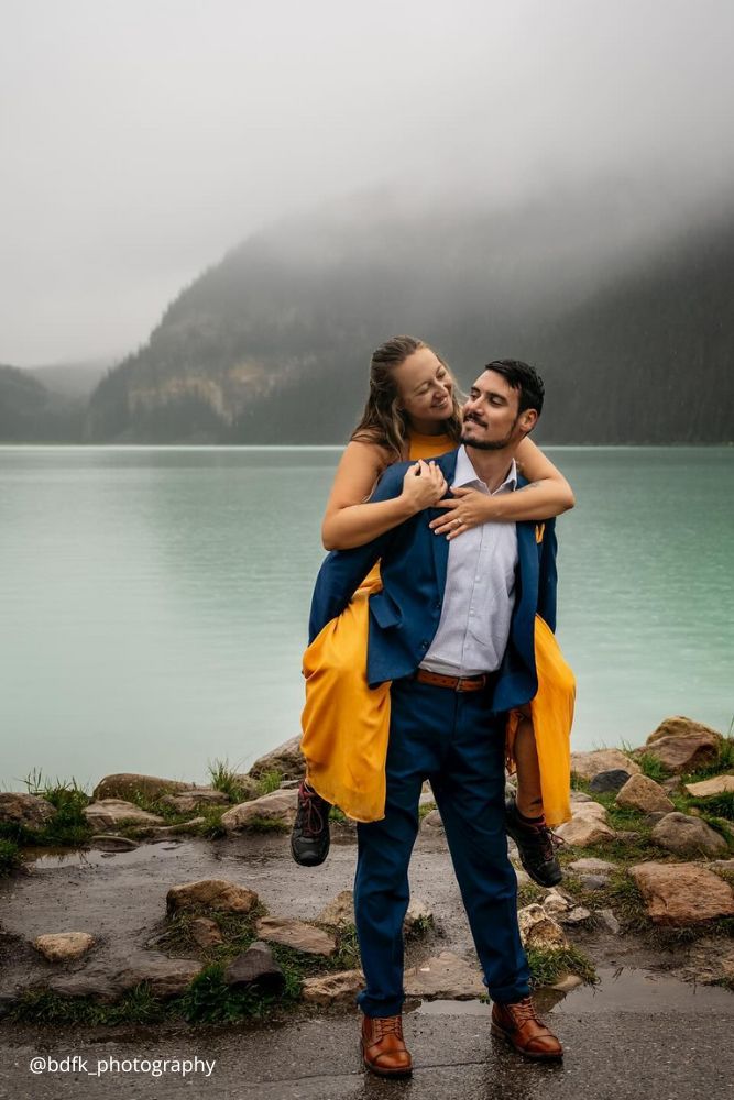 winter engagement photos girl in yelow gress o the back of her boy bdfk photography