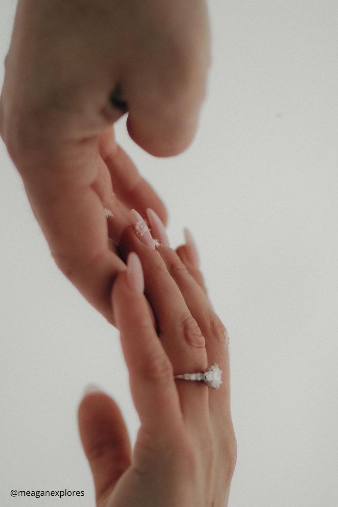 winter engagement photos hand in hand girl has ringr on her ring finger meaganexplores