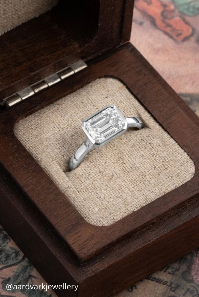 white gold engagement rings emerald cut diamond ring with sleek bezel setting in white gold aardvarkjewellery