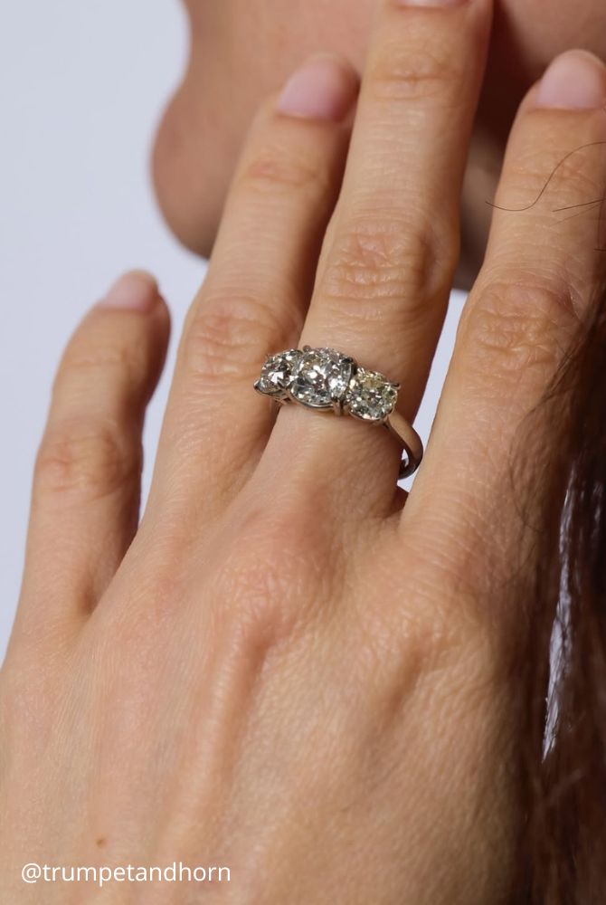 vintage engagement rings of white gold on hand three shining stones trumpetandhorn
