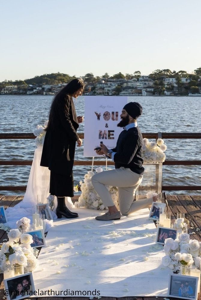 cheap proposal ideas proposal romantic moment pier dock waterside setting flowers candles michaelarthurdiamonds