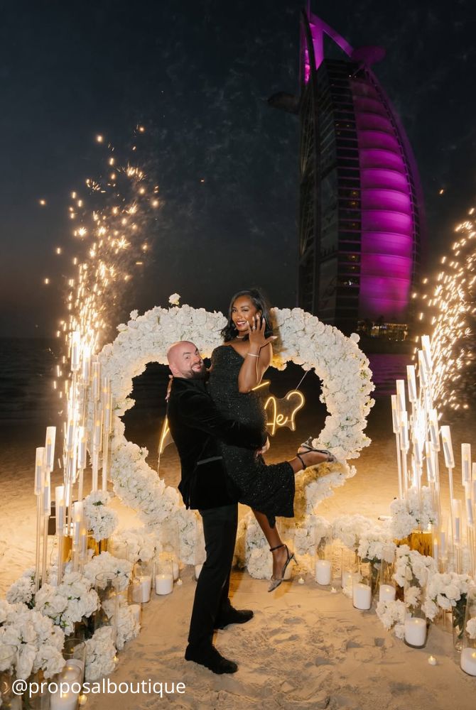 engagement photos hugs newlyweds romantic photo incredible background lights lights fireworks proposalboutique