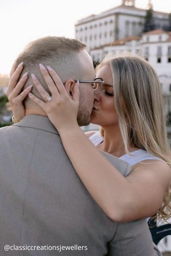 engagement photos hugs newlyweds romantic photo kiss against the city background classiccreationsjewellers