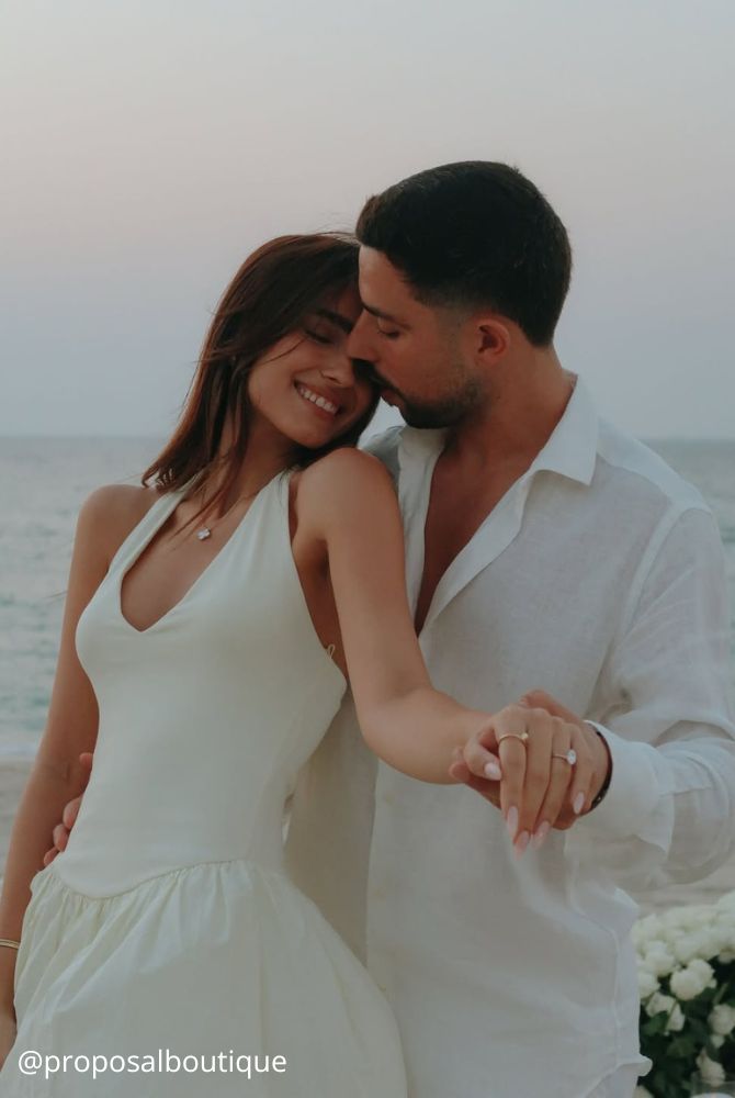 engagement photos hugs newlyweds romantic photo on the beach around the sea ring on the hand proposalboutique