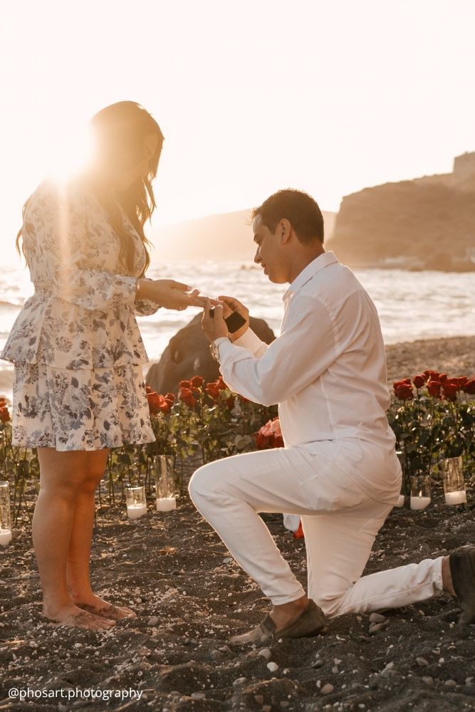 valentines day proposal guy proposes to a girl on the beach with lot of roses around phosart.photography